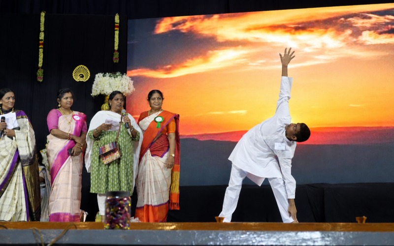 Student performing yoga on stage during a school event