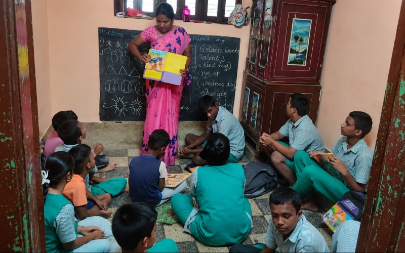 Teacher reading to students in a special education classroom